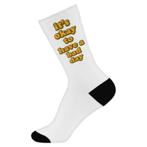 Novelty socks with comforting "It's Ok" motivational statement.