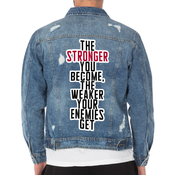 Front view of a man wearing a distressed denim jacket with motivational details.