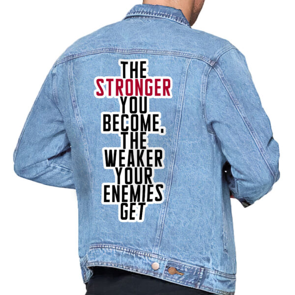 Front view of a man wearing a light washed denim jacket with motivational details.